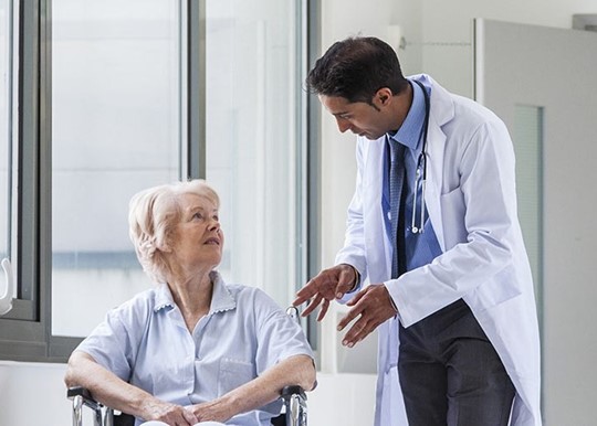 a doctor talking with a seated patient
