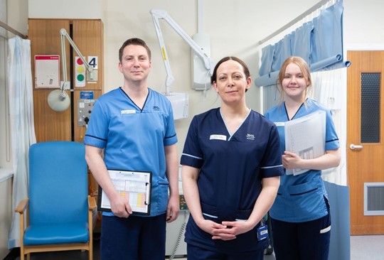 three NHS staff in uniform