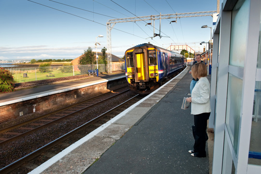 Woman Waiting For Train At A Rural Station