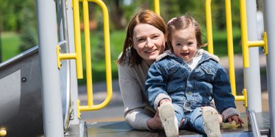 Smiling Mother And Child On Climbing Frame