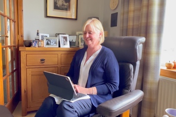 patient in chair using laptop