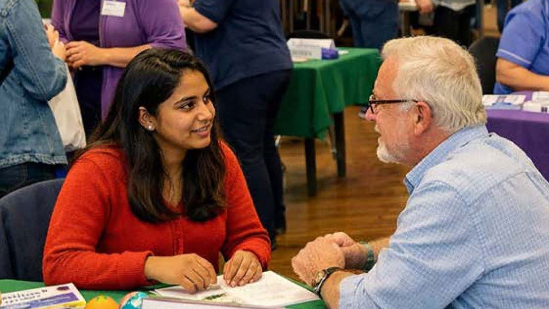 Two People At A Table Talking