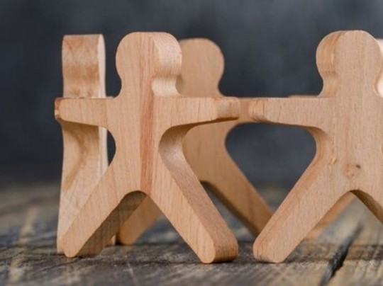 Wooden People Joining Hands