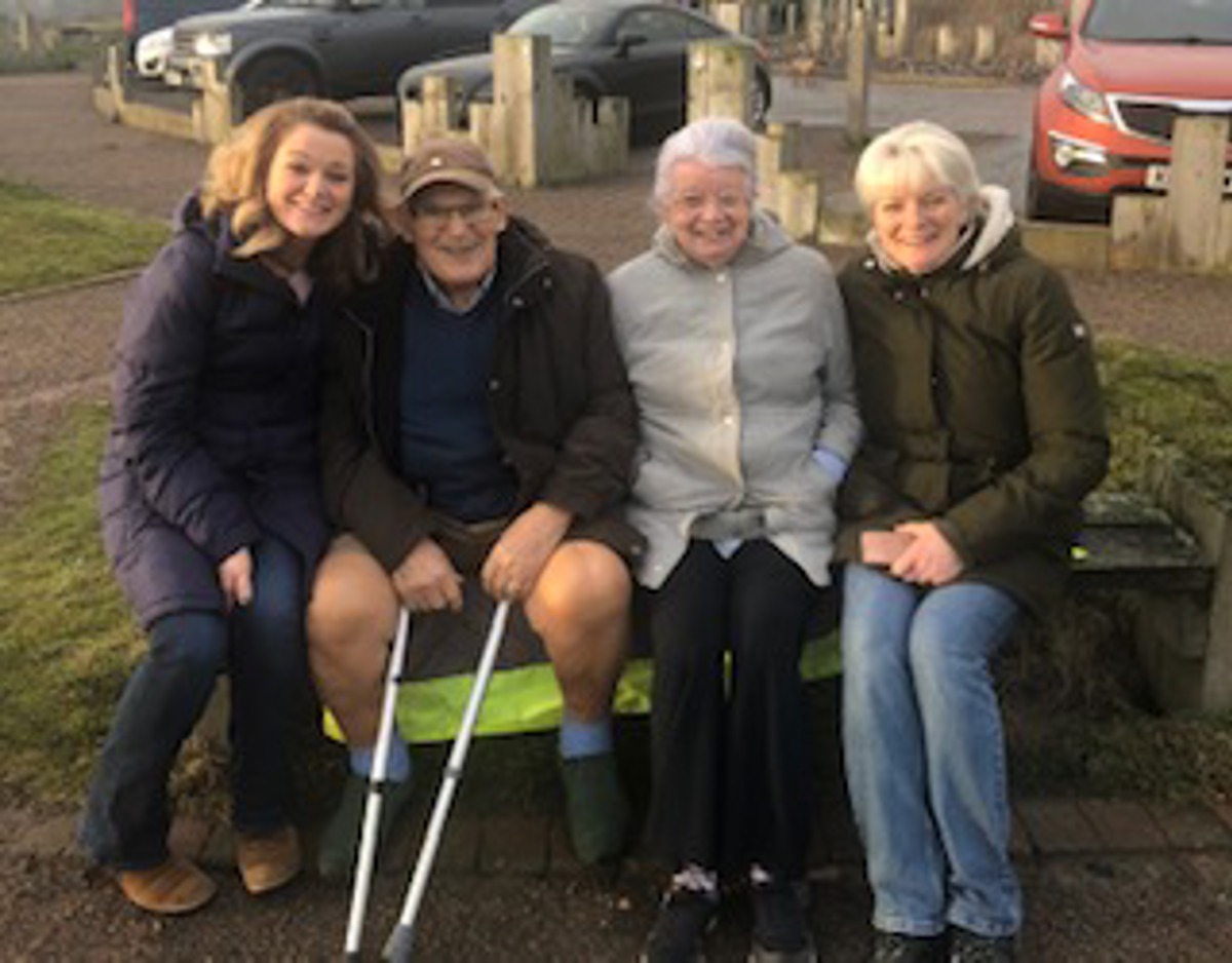 Family Sitting Outdoors Smiling