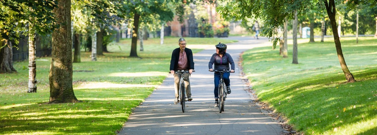 Two Cyclists In Urban Nature